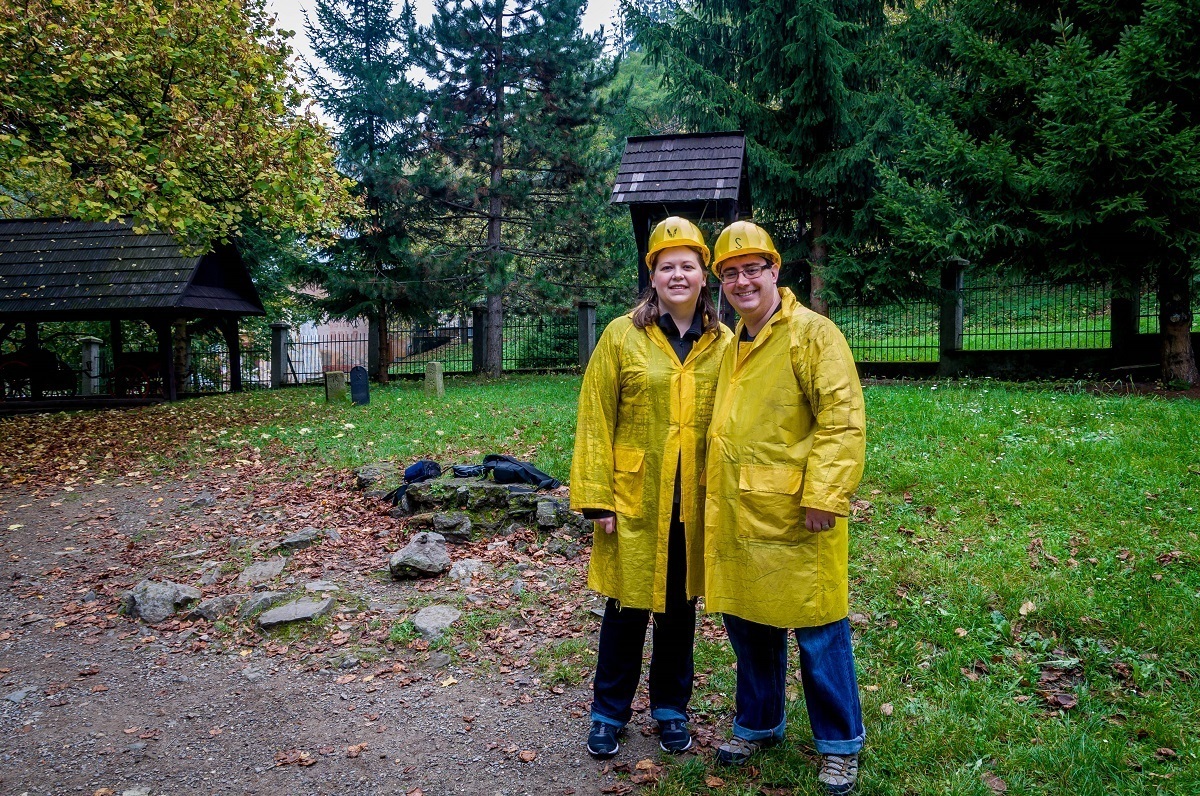 Two people wearing helmets and yellow coats.