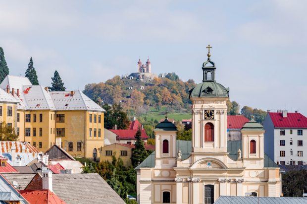 Buildings and a church at the base of a hill