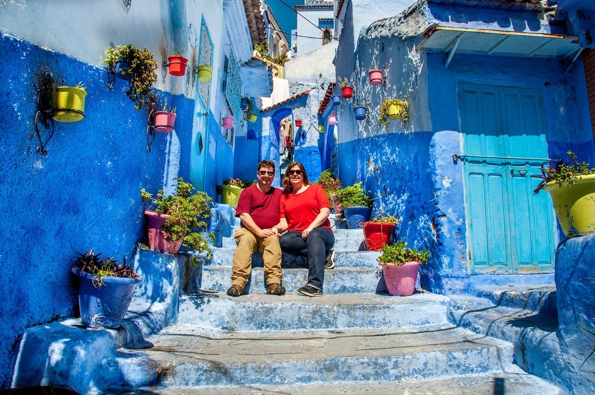 Two people sitting on blue steps.