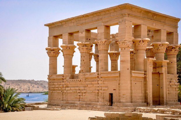 Ancient Egyptian temple with columns by a lake