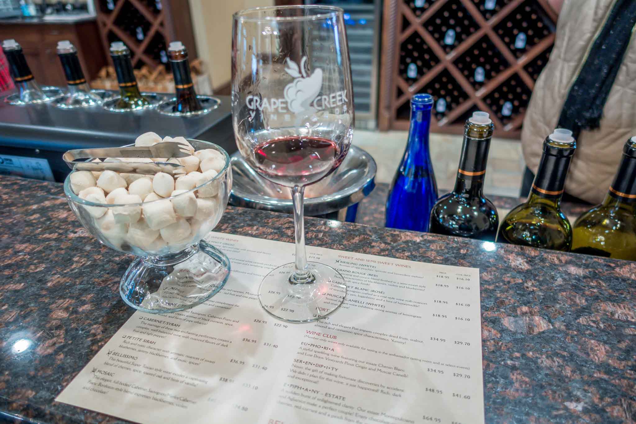 Wine glass and tasting menu at Grape Creek Vineyards