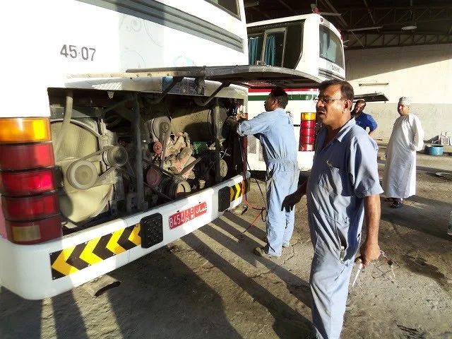 Mechanics working on the Mwasalat Buses after a breakdown